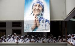 A poster of Blessed Teresa of Kolkata and Missionaries of Charity are seen in Kolkata, India, in this Sept. 5, 2007, file photo. Pope Francis will declare her a saint at the Vatican Sept. 4, the conclusion of the Year of Mercy jubilee for those engaged in works of mercy. (CNS photo/Jayanta Shaw, Reuters) See POPE-SAINTS-DATES March 15, 2016.
